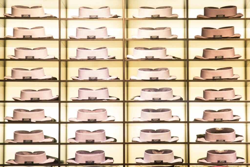 Organized collection of neatly stacked dress shirts showcased on shelves in a stylish fashion store.